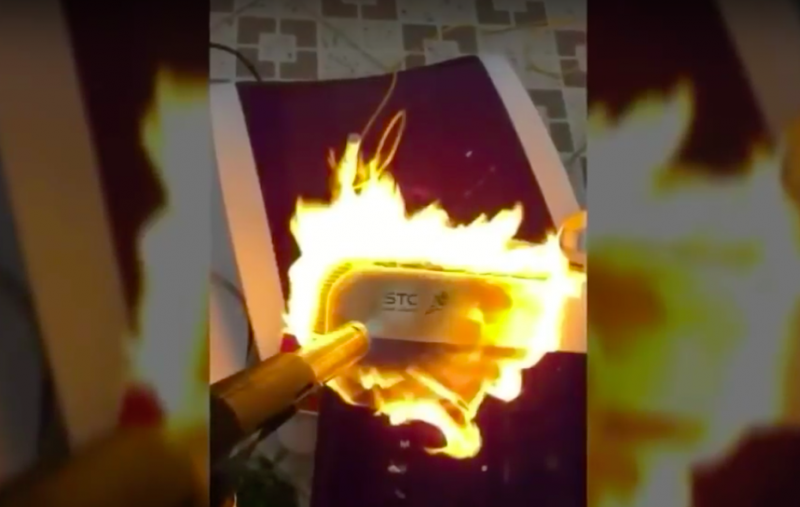 Screen capture from video of Saudi Telecom router being destroyed with blowtorch. Video shared on YouTube by 